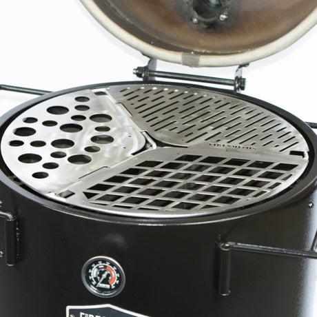 Close-up of the Firesmiths 3-in-1 stainless steel cooking grate system featuring interchangeable grill, searing, and vegetable cooking zones inside a Hero Smoker & Grill with the lid open.