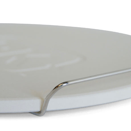 Close-up of the integrated stainless steel side carry handle on the Firesmiths cast iron braai lid, designed for safe lifting, easy transport, and secure handling.