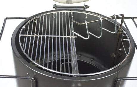 Firesmiths Hero Smoker & Grill with the lid open, featuring a stainless steel half cooking grate and integrated meat hanging hooks, allowing simultaneous grilling and wood-fired smoking in one versatile cooking system.