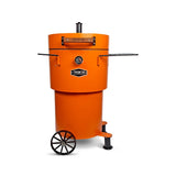 Firesmiths Hero Smoker & Grill in the Burnt Orange finish featuring a built-in temperature gauge, adjustable chimney, wooden handle, dual side shelves, and a wheeled base for premium wood-fired smoking and grilling.
