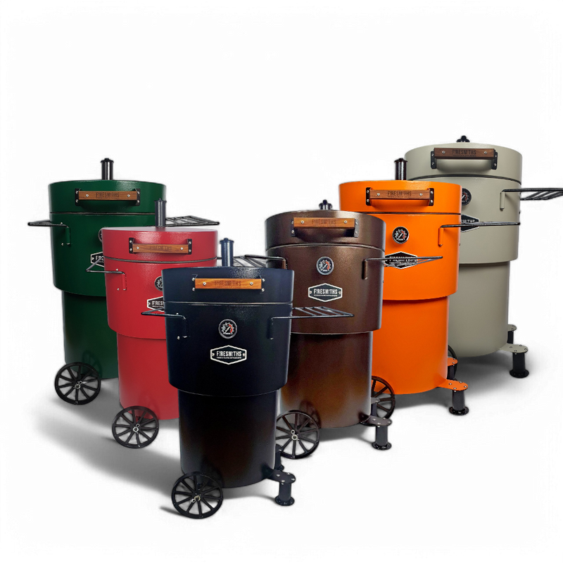 Collection of Firesmiths Hero Smoker & Grill models in matte black, forest green, crimson red, rustic bronze, bright orange, and sandstone finishes, each featuring a built-in temperature gauge, wooden handle, side preparation shelves, transport wheels, and premium steel construction for wood-fired smoking and grilling.