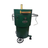 Firesmiths Hero Smoker & Grill in a forest green finish featuring a brass chimney, wooden handle, built-in temperature gauge, hanging hooks, dual side shelves, and a wheeled base for premium wood-fired smoking and grilling.