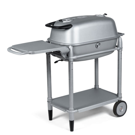 Firesmiths PK360 Silver charcoal grill with a heavy-duty rolling cart, folding side shelf, lower storage shelf, cast aluminum body, and precision airflow controls for professional outdoor grilling and smoking.