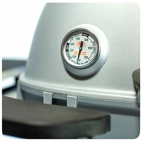 Close-up of the built-in temperature gauge on a Firesmiths PK Series cast aluminum charcoal grill, providing accurate heat monitoring for precise grilling and smoking.