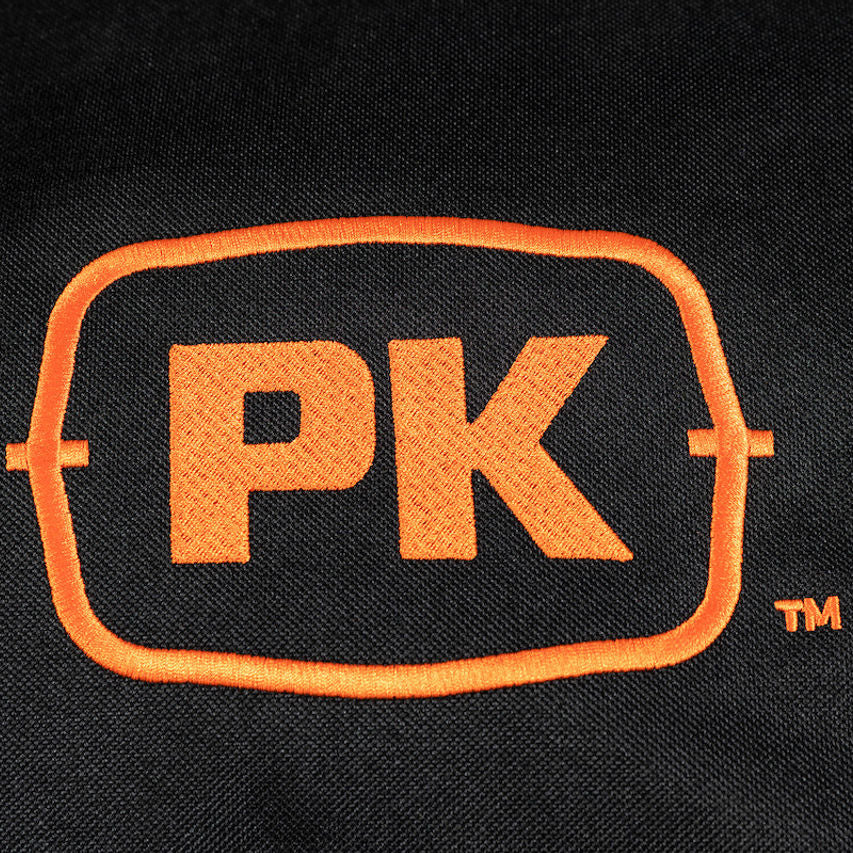 Close-up of the embroidered PK Series logo stitched in orange on durable black fabric, featured on the premium Firesmiths weather-resistant grill cover.