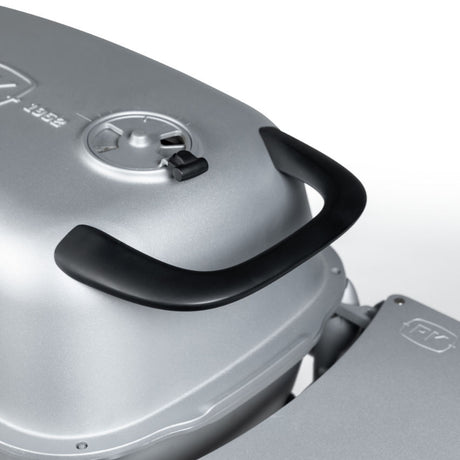 Close-up of the Firesmiths PK Series cast aluminum charcoal grill featuring the ergonomic heat-resistant lid handle and precision adjustable air vent for comfortable, controlled grilling and smoking.