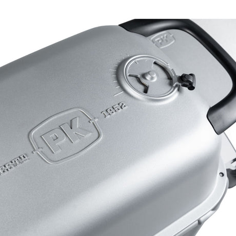 Close-up of the Firesmiths PK Series cast aluminum charcoal grill lid featuring the embossed PK logo, precision adjustable air vent, and durable heat-resistant handle for accurate temperature control.