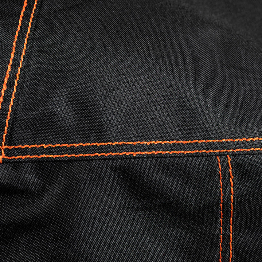 Close-up of the durable black fabric and reinforced orange stitching on the Firesmiths PK Series premium grill cover, showcasing high-quality craftsmanship and weather-resistant construction.