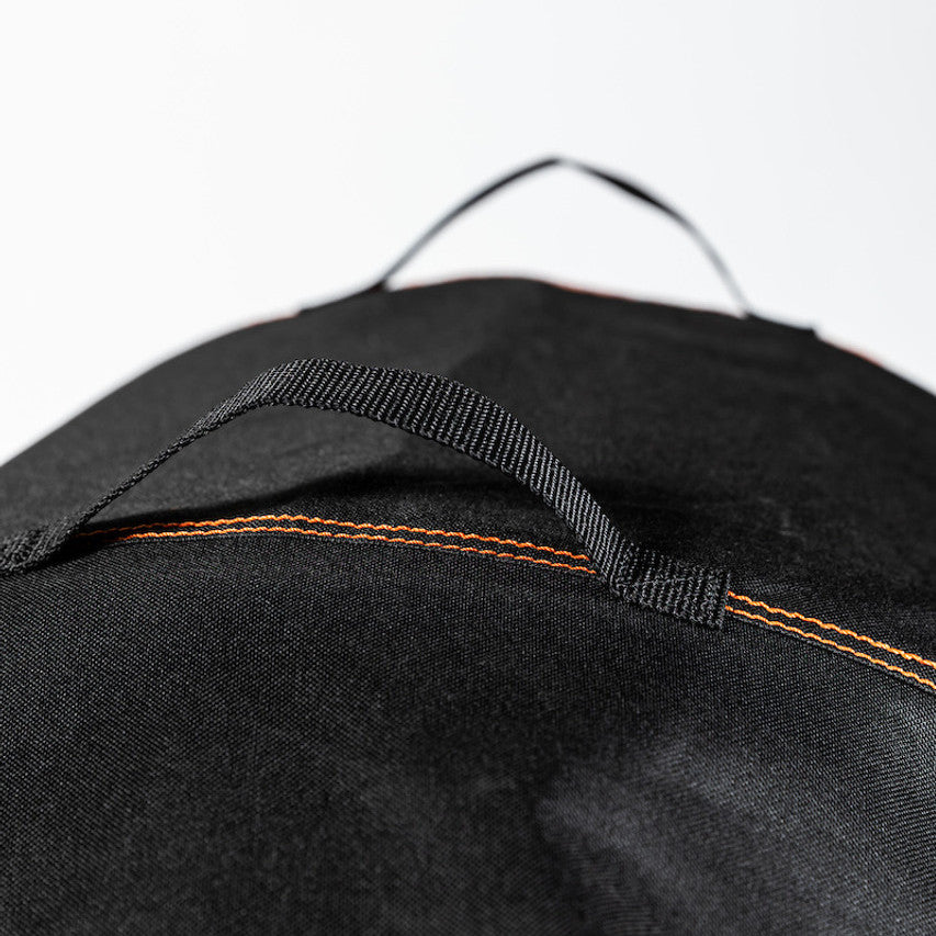 Close-up of the reinforced carry handle on the Firesmiths PK Series premium grill cover, featuring durable weather-resistant fabric and heavy-duty stitching for easy handling and storage.