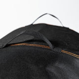 Close-up of the reinforced carry handle on the Firesmiths PK Series premium grill cover, featuring durable weather-resistant fabric and heavy-duty stitching for easy handling and storage.