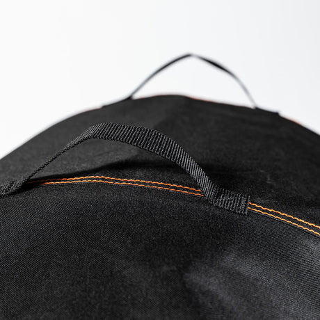 Close-up of the reinforced carry handle on the Firesmiths PK Series premium grill cover, featuring durable weather-resistant fabric and heavy-duty stitching for easy handling and storage.