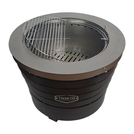 Firesmiths Smokeless Fire Pit featuring a removable stainless steel grill grate, allowing you to switch effortlessly between clean-burning outdoor fires and open-fire grilling for versatile outdoor cooking.