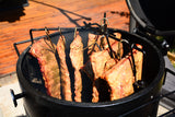 Stainless steel smoking hook rack set holding thick cuts of meat inside a Firesmiths Hero Smoker & Grill, designed for hanging ribs, brisket, and other large cuts for even wood-fired smoking.
